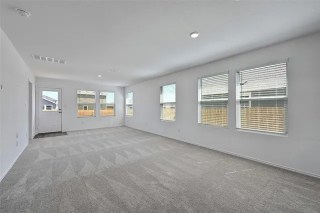 an empty room with windows and entrance