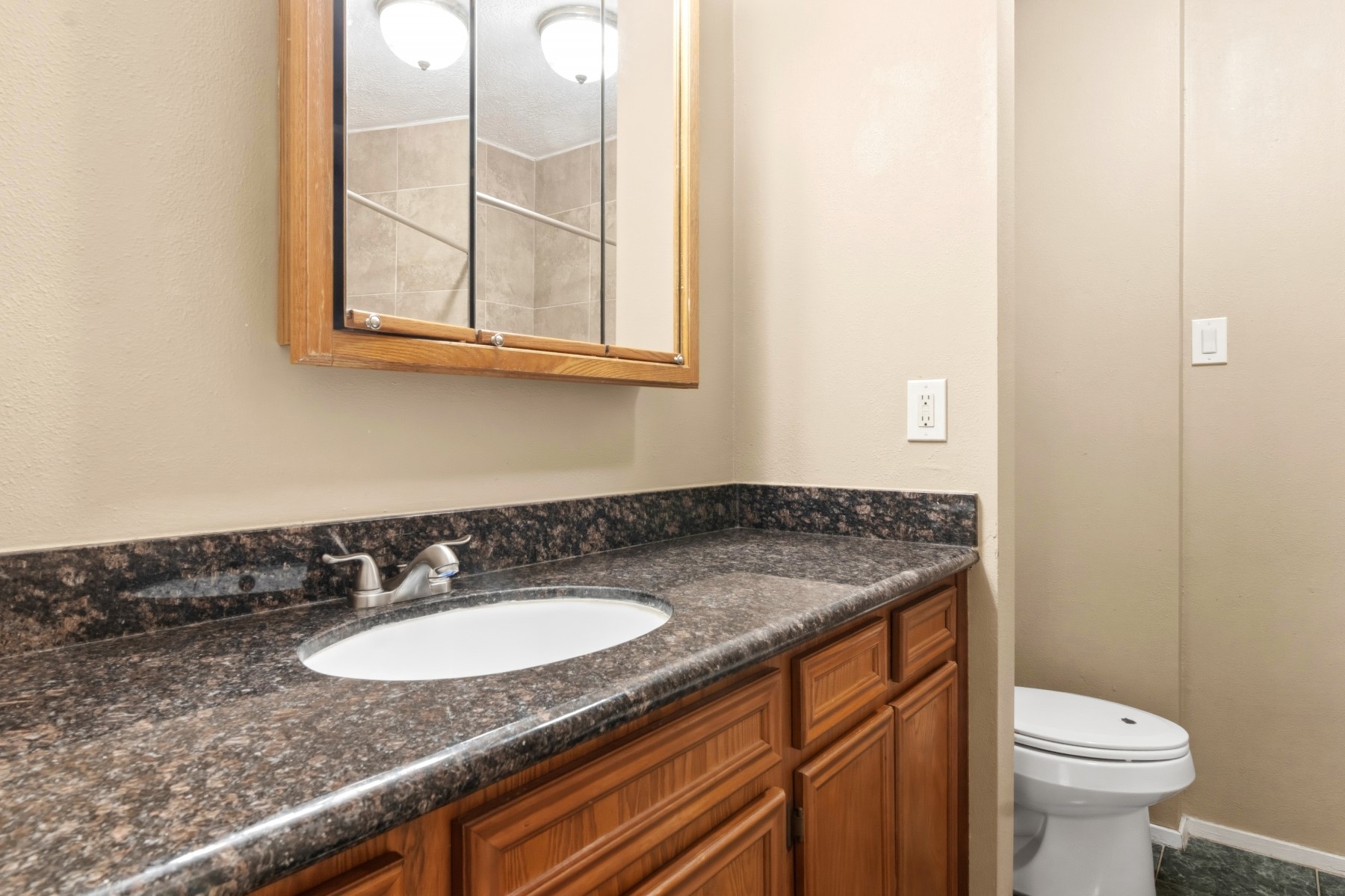 2531 North Spring Drive Spring, TX 77373 - Photo 20 of 24 a bathroom with a granite countertop sink and a toilet
