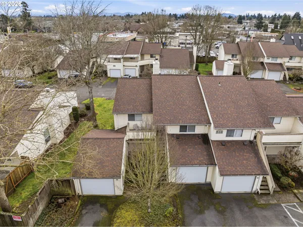 an aerial view of a house with a yard lake and mountain view