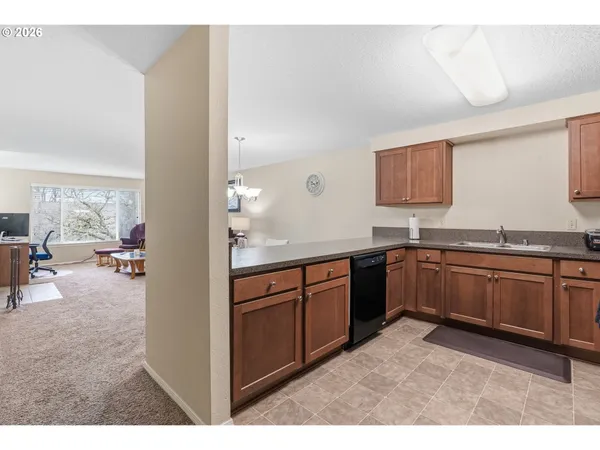 a kitchen with granite countertop a sink and cabinets