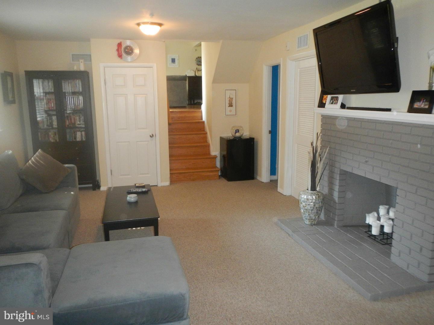 9002 Dunloggin Road Ellicott City, MD 21042 - Photo 14 of 25 a living room with furniture and a flat screen tv