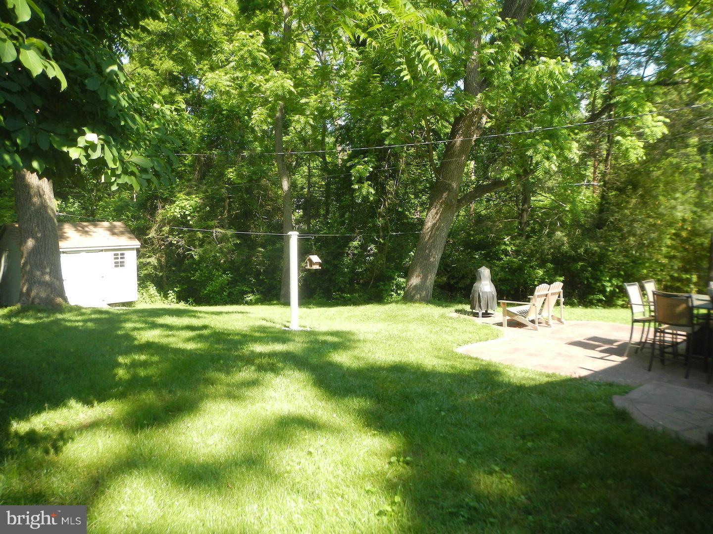 9002 Dunloggin Road Ellicott City, MD 21042 - Photo 3 of 25 a view of a backyard with a garden and trees