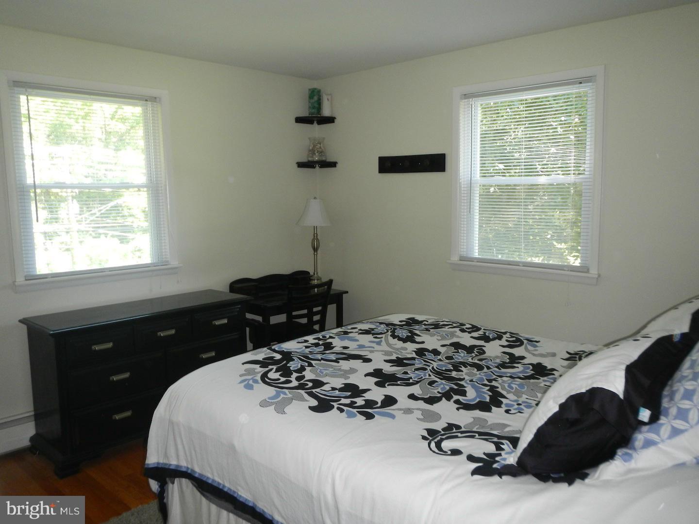 9002 Dunloggin Road Ellicott City, MD 21042 - Photo 22 of 25 a bedroom with a bed and a window