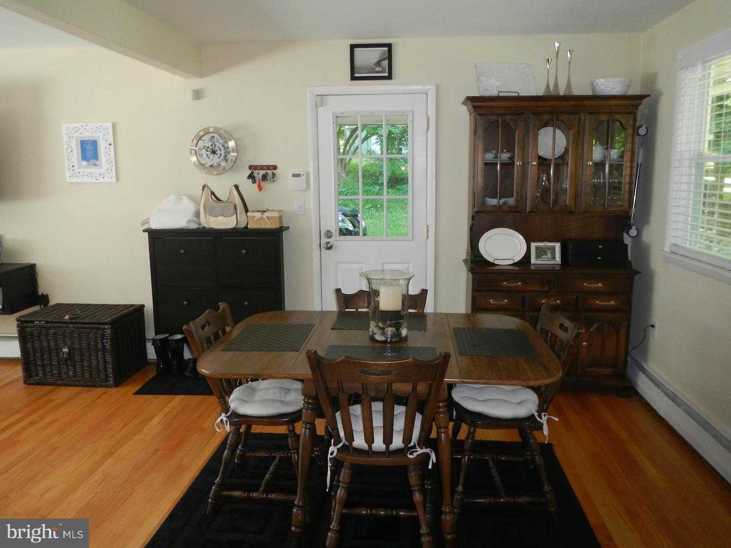 9002 Dunloggin Road Ellicott City, MD 21042 - Photo 8 of 25 a view of a dining room with furniture window and wooden floor
