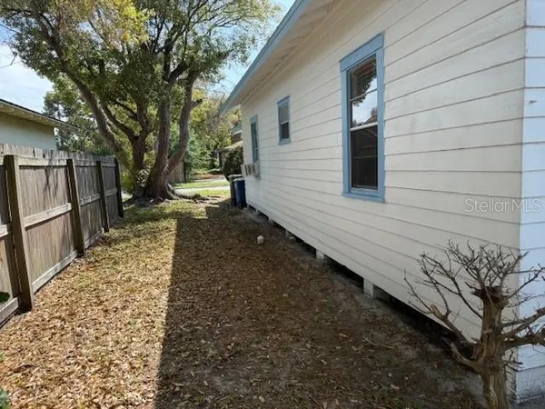 a backyard of a house with wooden fence