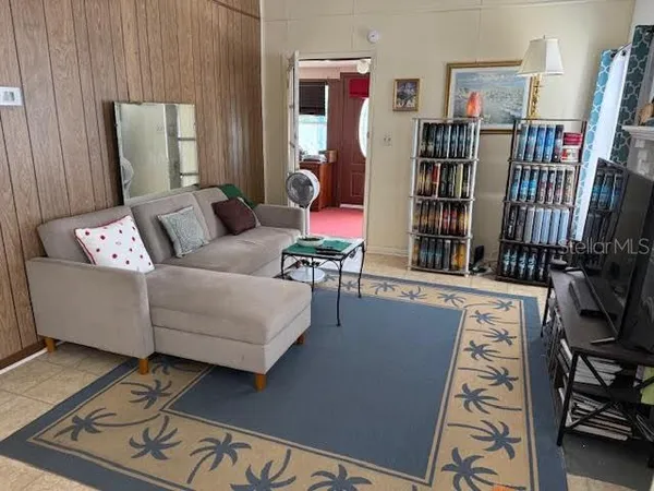 a living room with furniture and book shelf
