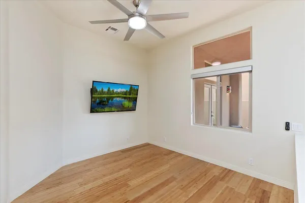 a view of a livingroom with a ceiling fan and window