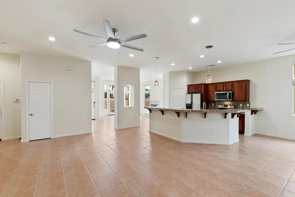 a living room with stainless steel appliances kitchen island furniture and a view of kitchen