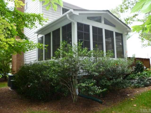 6424 Wynbrook Way Raleigh, NC 27612 - Photo 11 of 12 a view of a house with potted plants and large trees
