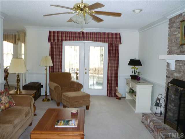 6424 Wynbrook Way Raleigh, NC 27612 - Photo 4 of 12 a living room with furniture and a fireplace