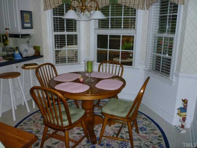 6424 Wynbrook Way Raleigh, NC 27612 - Photo 7 of 12 a table and chairs in a livingroom