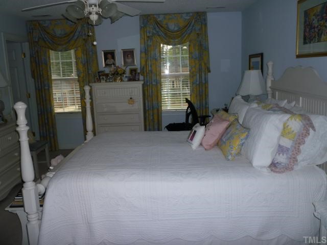 6424 Wynbrook Way Raleigh, NC 27612 - Photo 8 of 12 a bed room with a bed and a window