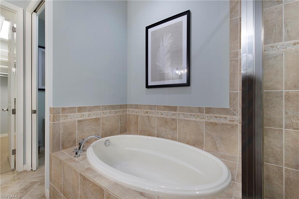 8975 Malibu Street, Unit 1304 Naples, FL 34113 - Photo 17 of 43 a bathroom with a bathtub