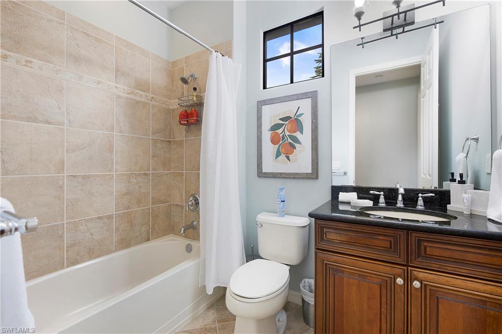 8975 Malibu Street, Unit 1304 Naples, FL 34113 - Photo 21 of 43 a bathroom with a bathtub sink vanity mirror and toilet
