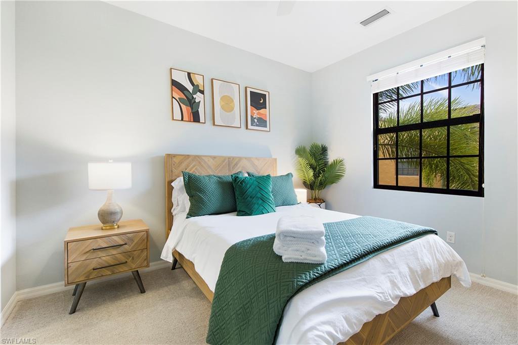 8975 Malibu Street, Unit 1304 Naples, FL 34113 - Photo 22 of 43 a bedroom with a bed and a window