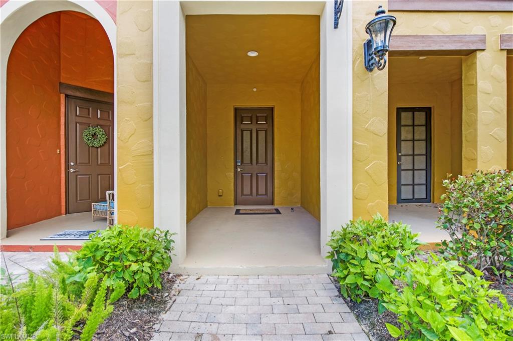 8975 Malibu Street, Unit 1304 Naples, FL 34113 - Photo 26 of 43 a front view of a house with garden