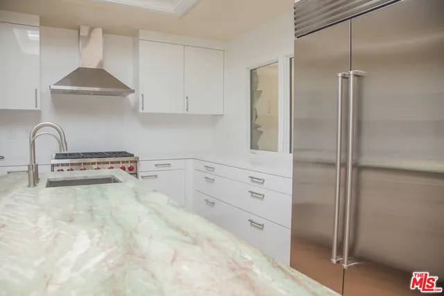 a kitchen with stainless steel appliances a refrigerator and a stove