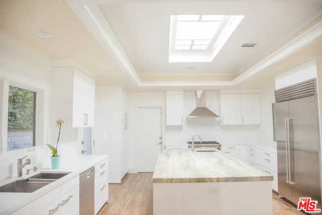 a bathroom with a granite countertop sink a mirror and shower
