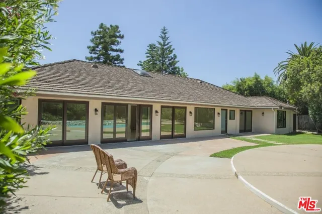 a house view with a sitting space and garden