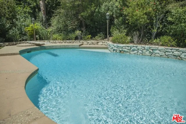 a view of swimming pool with a yard