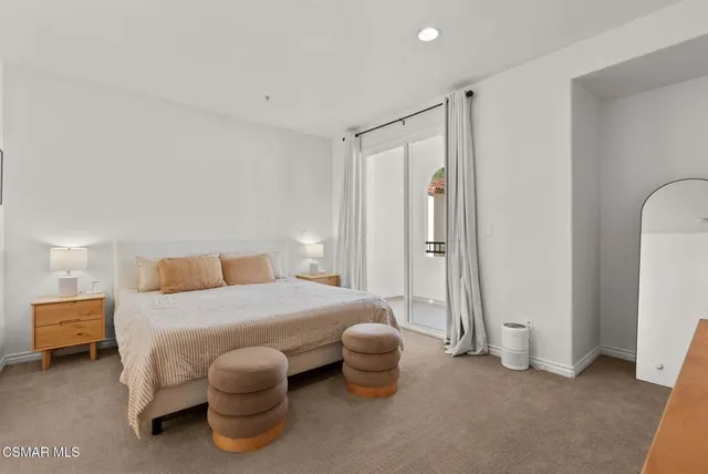 a bedroom with a bed and a table