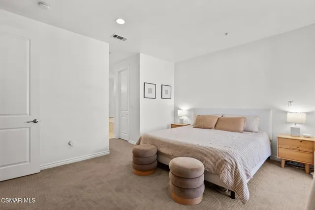 a bedroom with a bed and lamp