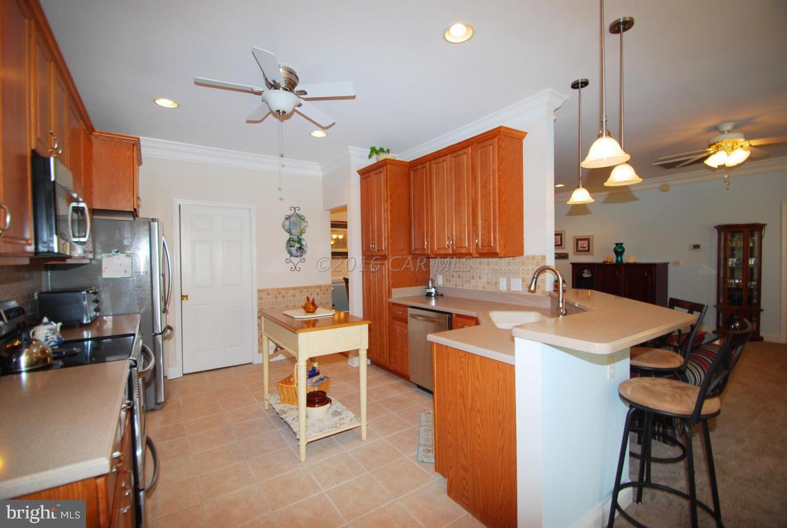 51 Pinehurst Road Ocean Pines, MD 21811 - Photo 11 of 50 a kitchen with a table chairs refrigerator and cabinets