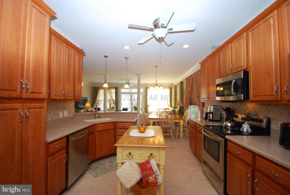 51 Pinehurst Road Ocean Pines, MD 21811 - Photo 13 of 50 a open kitchen with stainless steel appliances granite countertop a sink a stove and cabinets
