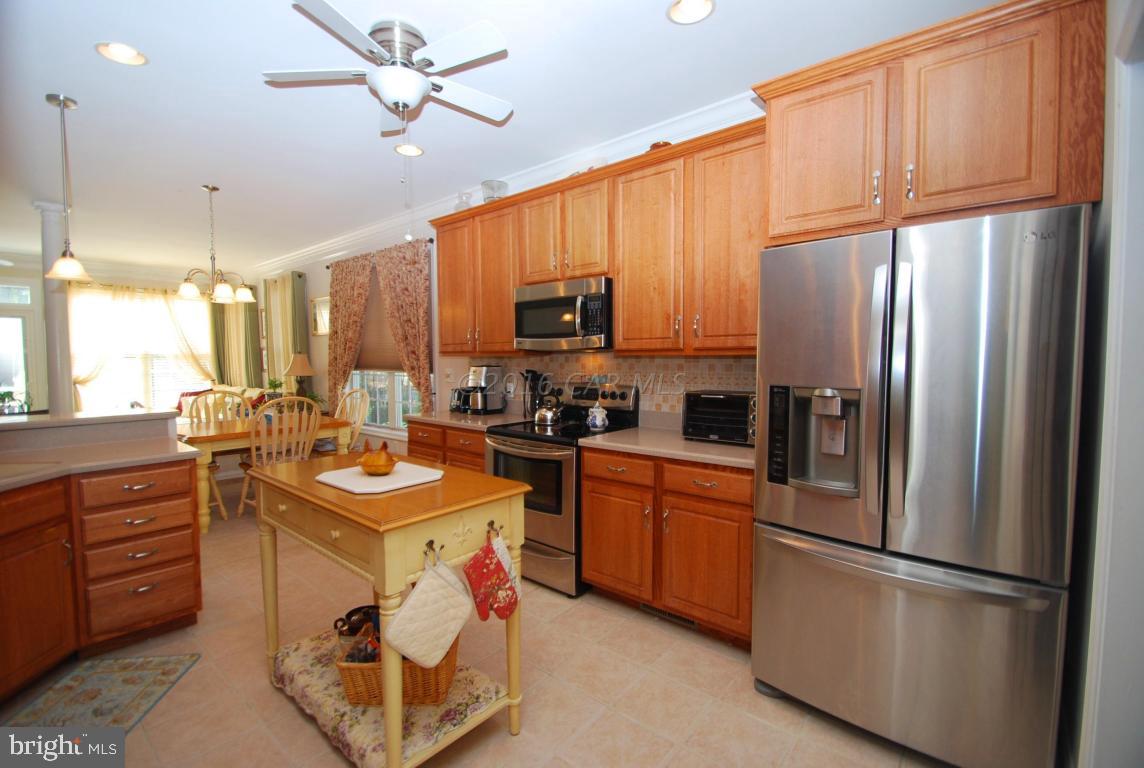 51 Pinehurst Road Ocean Pines, MD 21811 - Photo 14 of 50 a kitchen with stainless steel appliances granite countertop a refrigerator a sink dishwasher a stove with wooden cabinets and a refrigerator