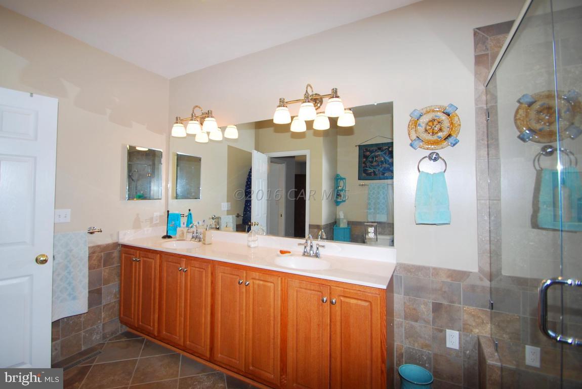 51 Pinehurst Road Ocean Pines, MD 21811 - Photo 25 of 50 a bathroom with a sink mirror and vanity