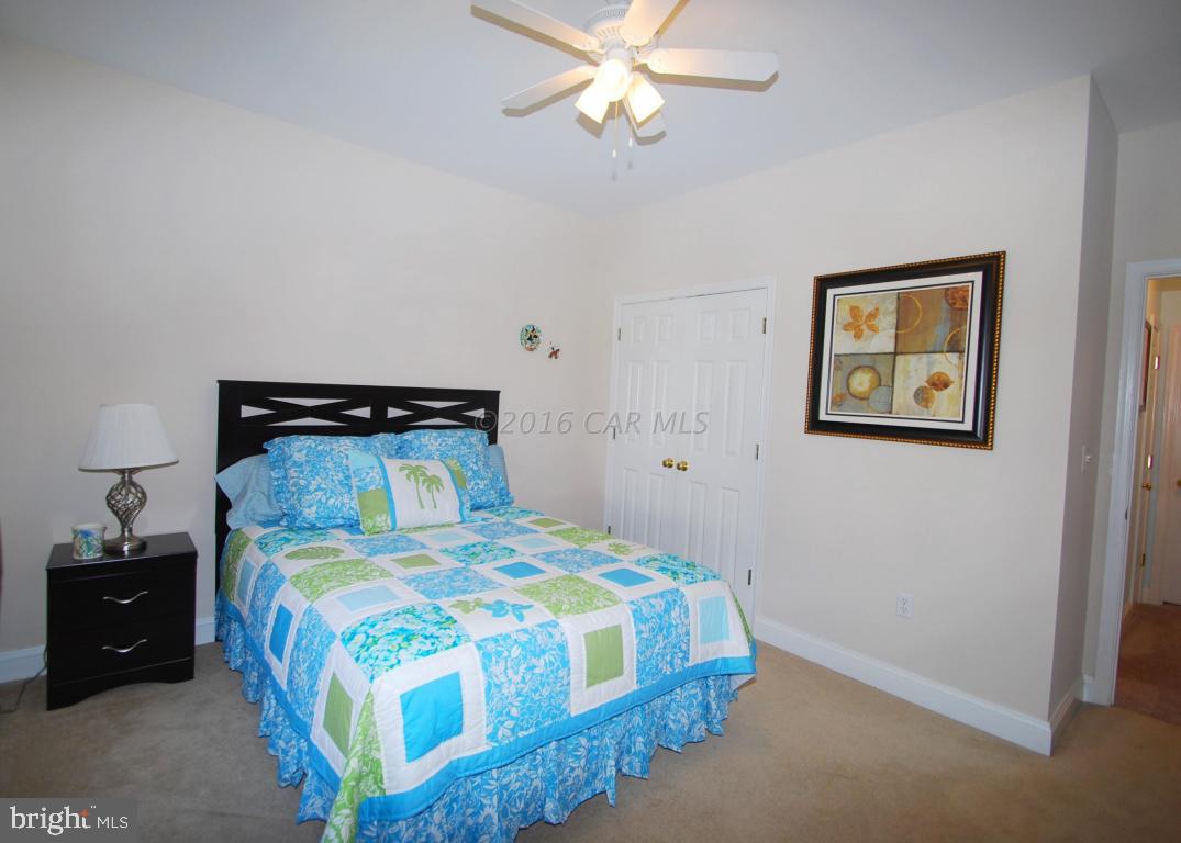 51 Pinehurst Road Ocean Pines, MD 21811 - Photo 29 of 50 a bedroom with a bed and a chandelier
