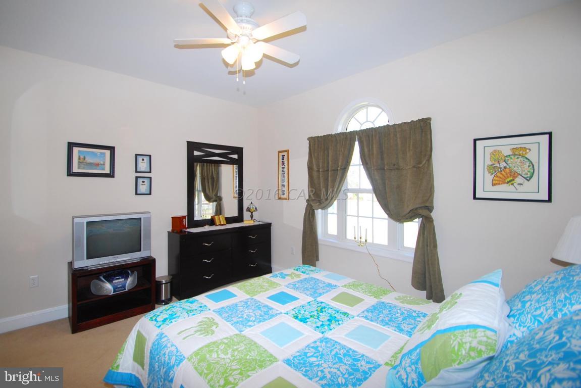 51 Pinehurst Road Ocean Pines, MD 21811 - Photo 30 of 50 a bedroom with a bed and a chandelier