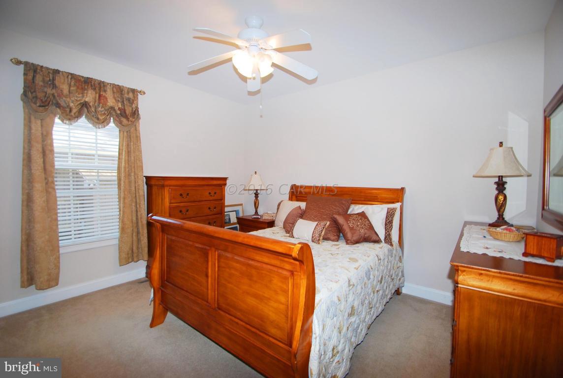 51 Pinehurst Road Ocean Pines, MD 21811 - Photo 31 of 50 a bed room with a bed and a chandelier