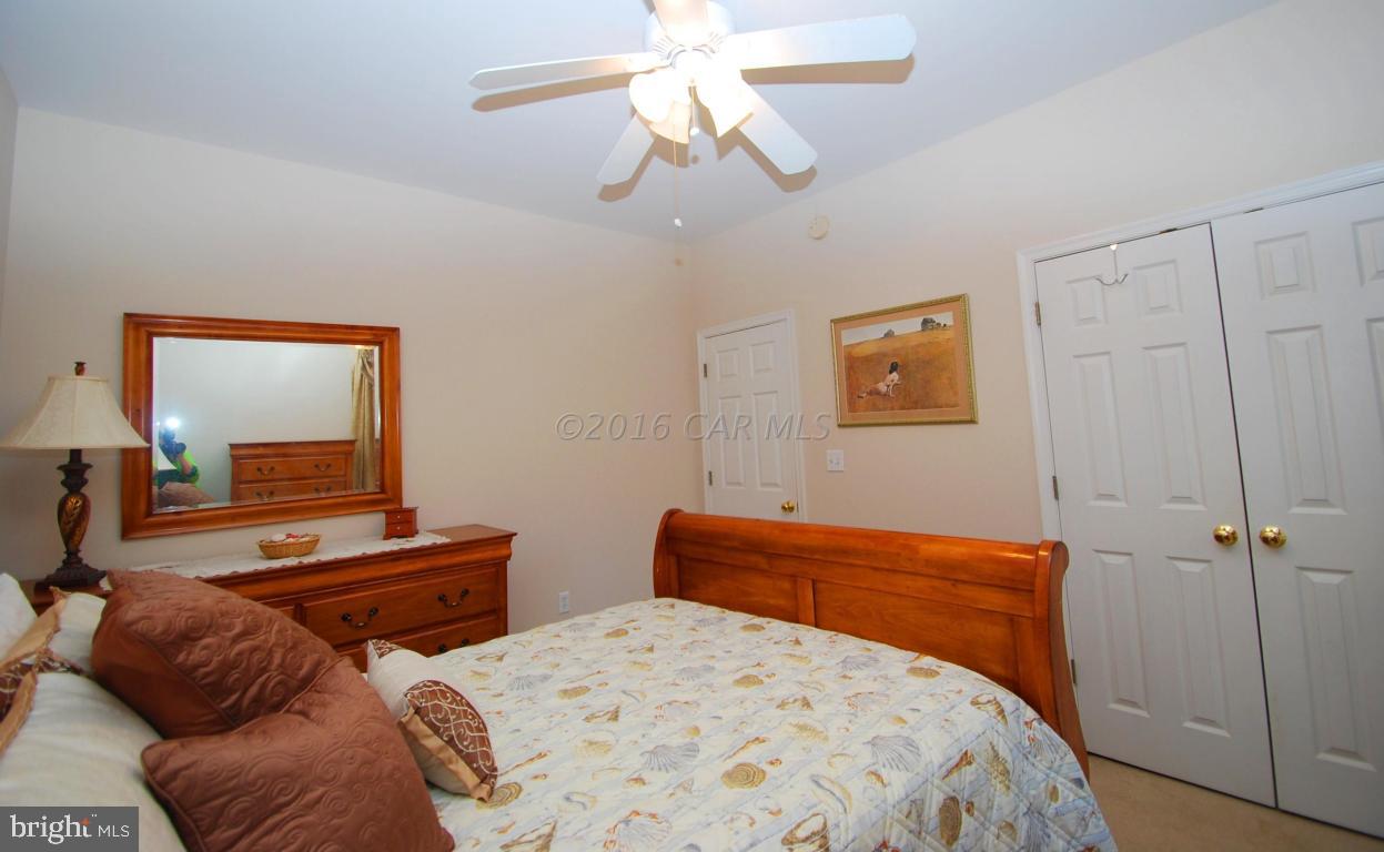 51 Pinehurst Road Ocean Pines, MD 21811 - Photo 32 of 50 a bedroom with two beds and a chandelier
