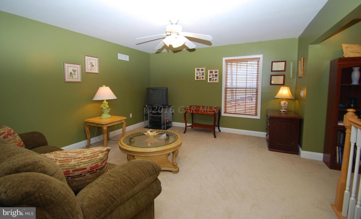 51 Pinehurst Road Ocean Pines, MD 21811 - Photo 34 of 50 a living room with furniture a chandelier and a flat screen tv