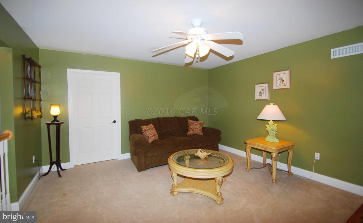 51 Pinehurst Road Ocean Pines, MD 21811 - Photo 35 of 50 a living room with furniture and a chandelier