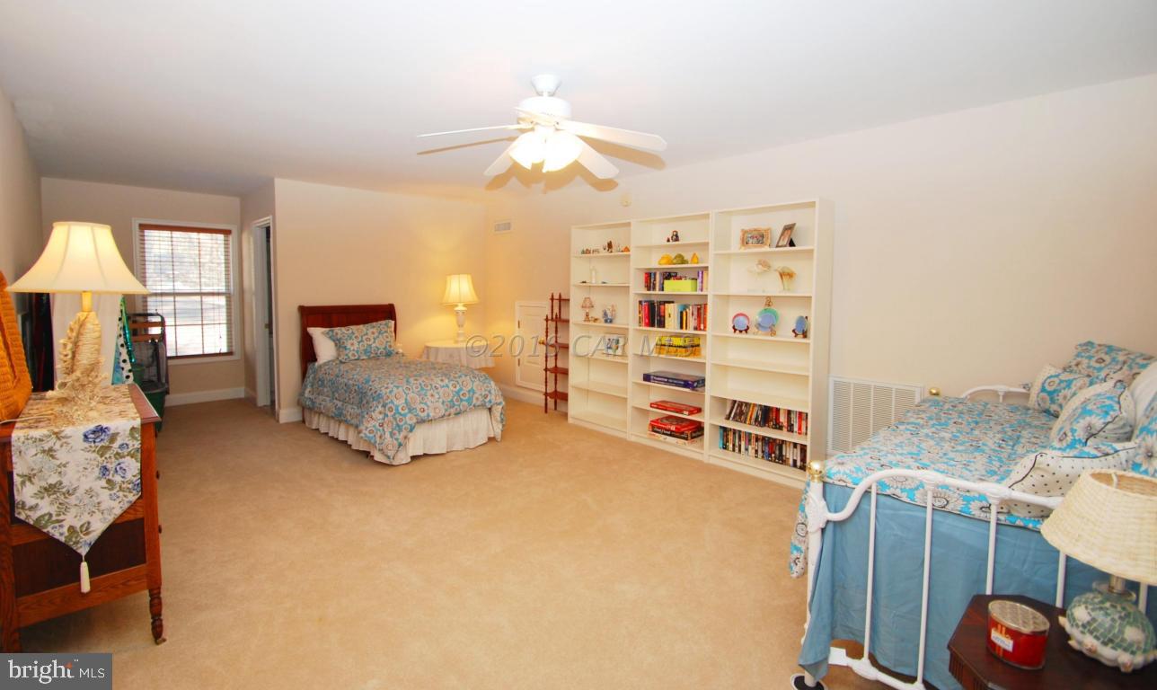51 Pinehurst Road Ocean Pines, MD 21811 - Photo 36 of 50 a spacious bedroom with a bed and a chandelier