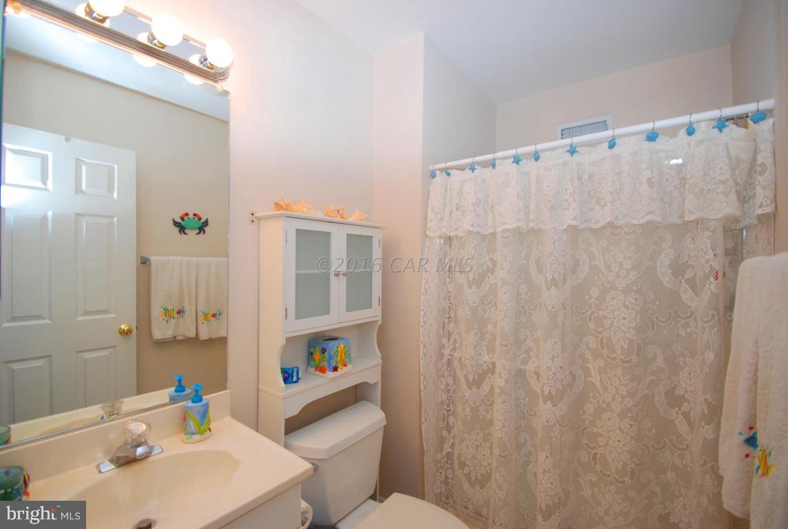 51 Pinehurst Road Ocean Pines, MD 21811 - Photo 39 of 50 a bathroom with a sink a toilet and shower curtain
