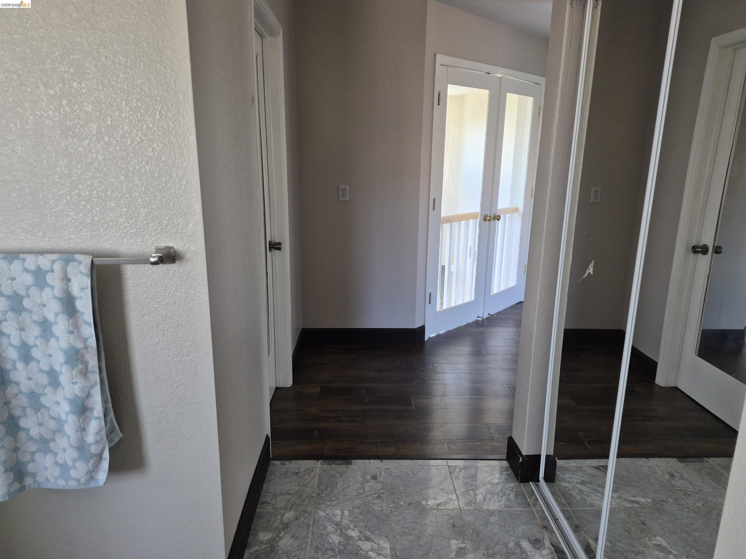 149 Oakpoint Court Bay Point, CA 94565 - Photo 9 of 22 Primary Bathroom looking out featuring wood-finish flooring, light grey walls, and white framed French doors