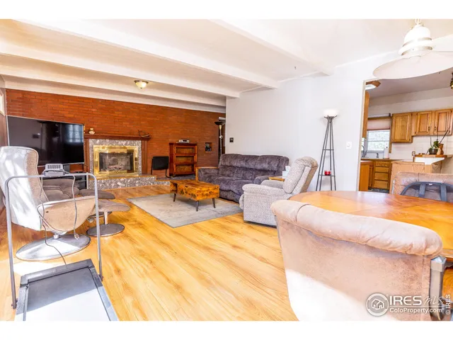 a spacious bedroom with a bed and a flat screen tv