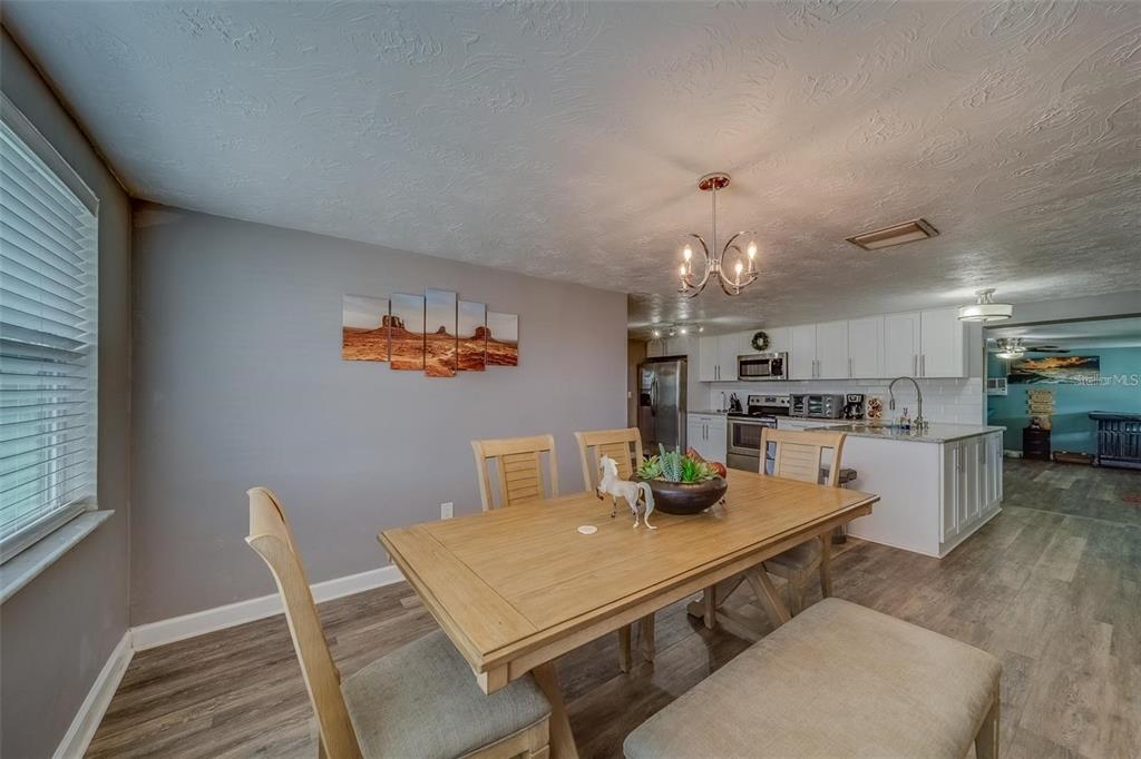 2646 Albion Street Holiday, FL 34691 - Photo 13 of 64 a kitchen with a dining table chairs and microwave