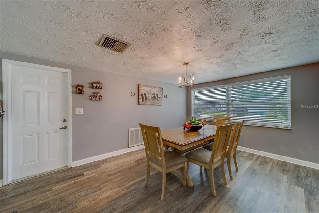 2646 Albion Street Holiday, FL 34691 - Photo 14 of 64 a view of a dining room with furniture window and wooden floor