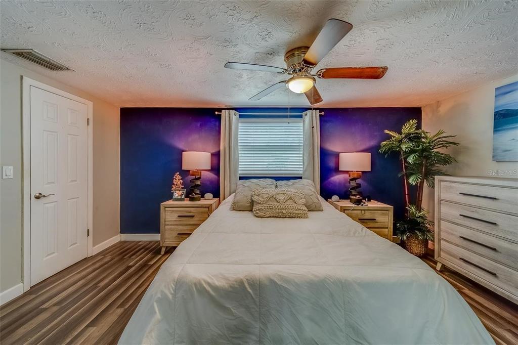 2646 Albion Street Holiday, FL 34691 - Photo 19 of 64 a bedroom with a bed and a chandelier