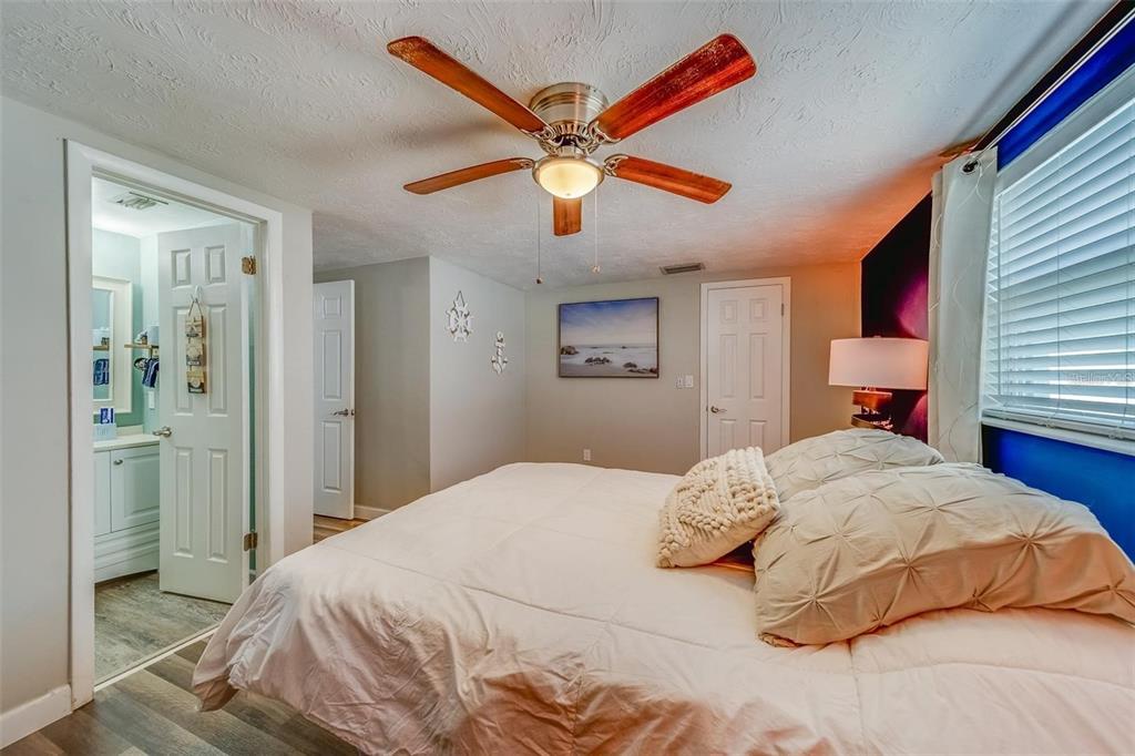 2646 Albion Street Holiday, FL 34691 - Photo 21 of 64 a bedroom with a bed and a chandelier