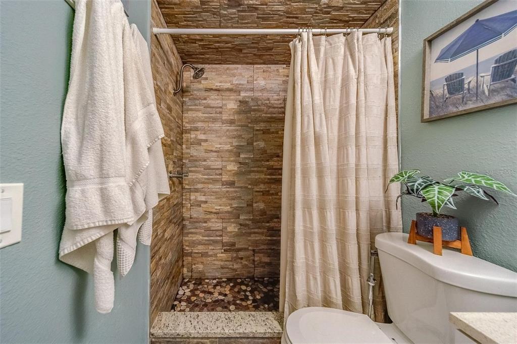 2646 Albion Street Holiday, FL 34691 - Photo 25 of 64 a bathroom with a toilet and shower curtain