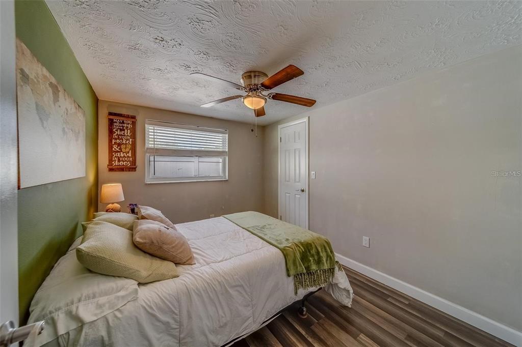 2646 Albion Street Holiday, FL 34691 - Photo 27 of 64 a bedroom with a bed and a chandelier