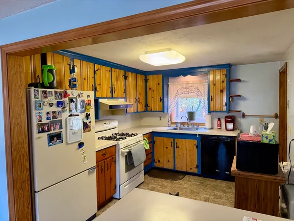a kitchen with stainless steel appliances granite countertop a stove and a refrigerator