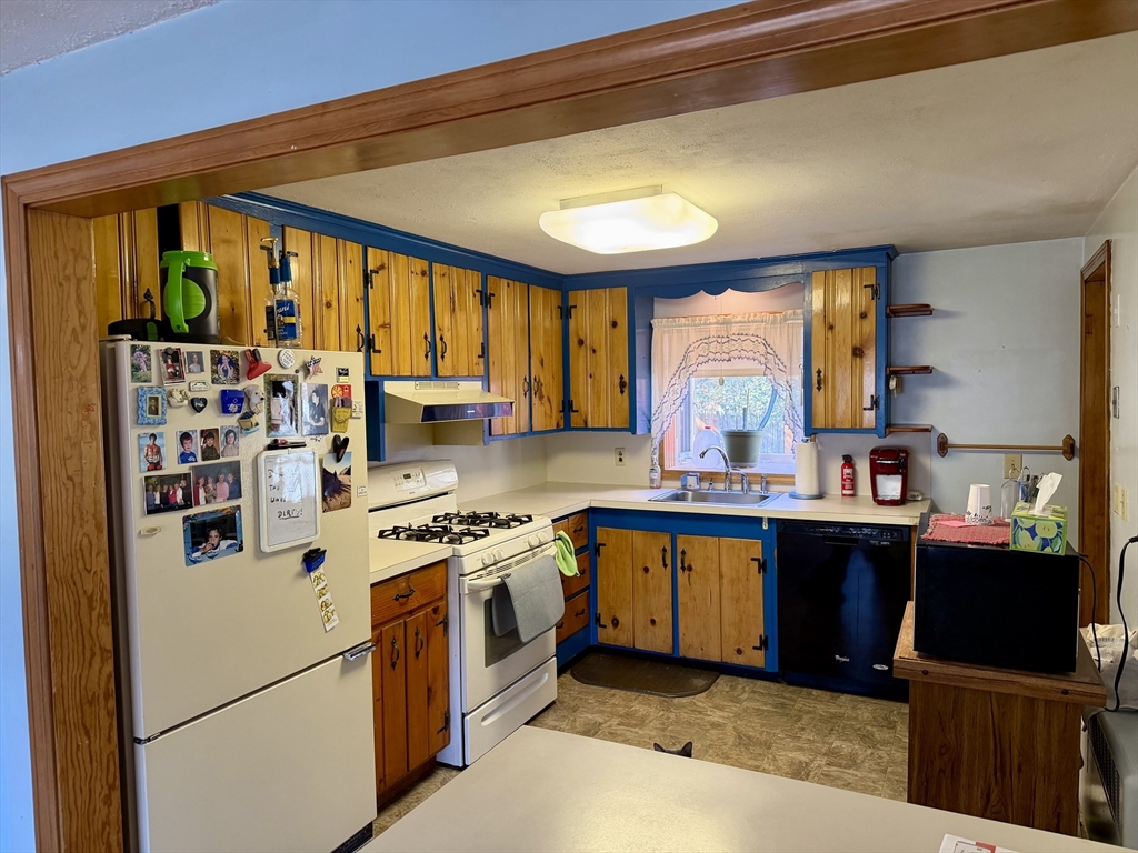 31 Pineywood Road Southwick, MA 01077 - Photo 3 of 12 a kitchen with stainless steel appliances granite countertop a stove and a refrigerator
