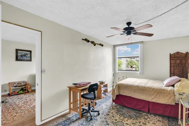 a bedroom with a bed a dresser and chair