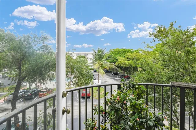 a view of a balcony with a plant in front of it